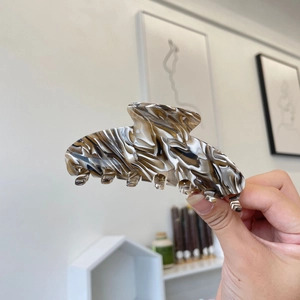 Large coffee marble acetate hair claw clip with elegant swirl patterns and glossy finish