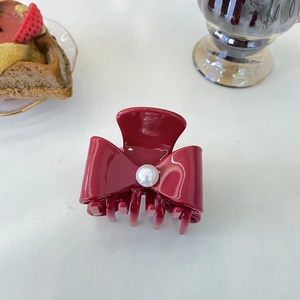 Elegant burgundy acetate hair claw with bow design and white pearl detail for women