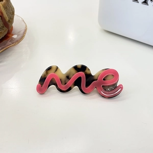 Golvende haarspeld van acetaat in schildpadmotief met roze 3D-letters 'me'