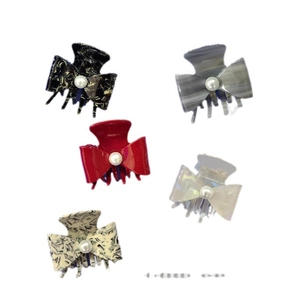 Five pieces of acetate bow hair claw clips with elegant pearl embellishments in various colors