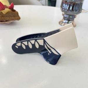 Elegant ballet flat style acetate hair claw clip with cream and navy contrast design