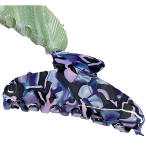 Elegant large acetate hair claw with purple and blue marble pattern on white background