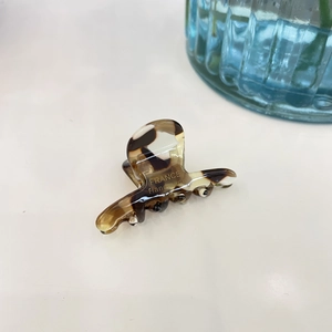 Close-up of leopard pattern hair claw showing the France Handmade gold lettering detail