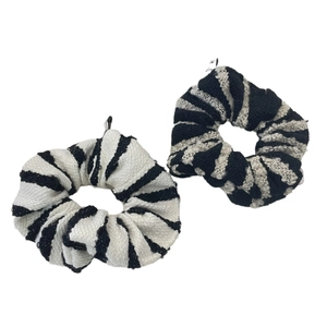 Set of two black and white zebra pattern knitted hair scrunchies on white background