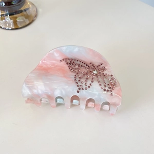 Pink marble texture hair claw clip with crystal butterfly embellishment and shark clip teeth