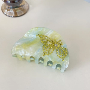 Luxurious butterfly hair claw clip with marble texture and sparkling yellow rhinestones