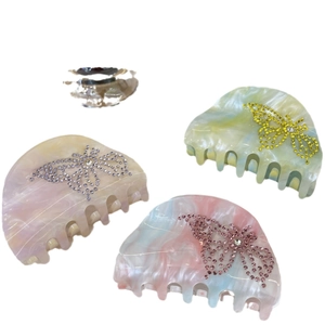 Three elegant butterfly hair claws with rhinestones in candy colors on white background