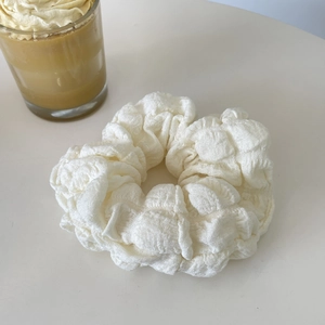 Chic cream white puff oversized scrunchie hair tie with bubble textured fabric on beige base