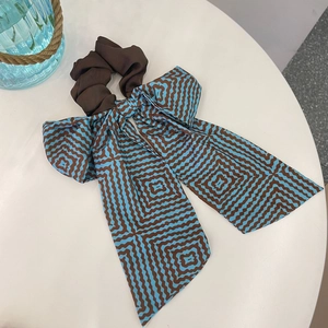 French style brown and blue geometric pattern bow scrunchie on white display stand