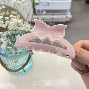 Elegant pink butterfly acrylic hair claw clip with subtle glitter for daily hair styling
