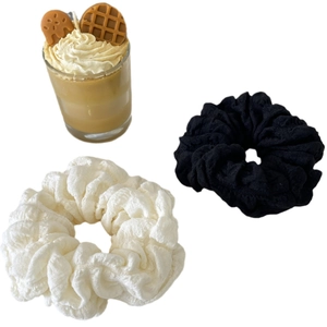 Set of two puffy scrunchies in black and white colors with wave pleated fabric texture