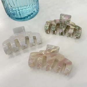 Three-piece set of elegant marble acetate large hair claw clips in neutral pastel colors