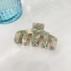 Elegant large marble textured acetate hair claw clip with pearlescent pastel swirl design