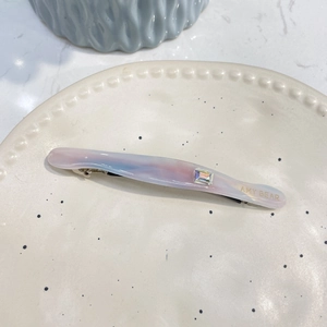 Détail d'une barrette en acide acétique avec marbre rose-bleu et cristal