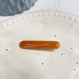 Elegant amber acetate hair clip with golden France Handmade lettering in minimalist style