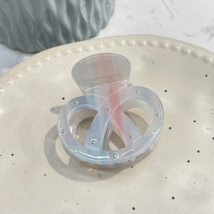 Translucent multicolored pretzel acetate hair claw clip with metallic studs decoration
