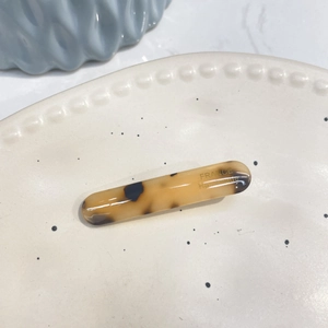 Detail of tortoiseshell acetate hair clip with gold France Handmade lettering