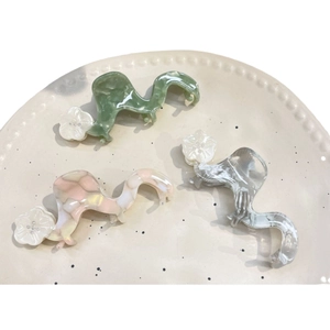 Three-piece acetate flower hair claws set in pink, green and grey marble patterns
