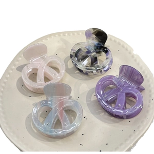 Chic acetate pretzel hair claws in four colors with embedded metallic silver studs