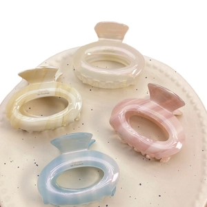 Chic acetate donut hair claws in pastel colors with Barrette la France gold lettering