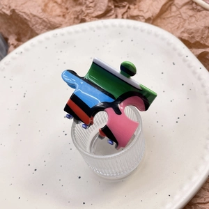 Creative puzzle shaped hair claw clip with colorful striped patterns in Y2K style
