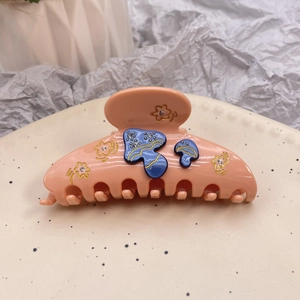 Pink acetate hair claw clip with blue mushroom and rhinestone flower design