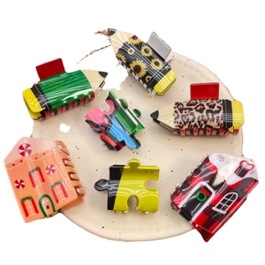 Chic acetate hair claw clip set with pencil, puzzle, and gingerbread house designs