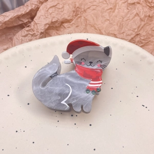 Pince à cheveux chat de Noël en acétate gris marbré avec un bonnet rouge festif