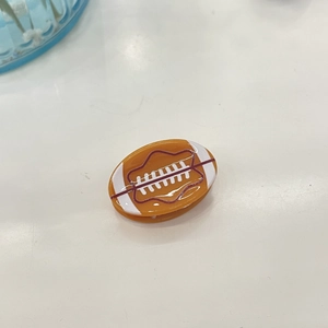 Pinza para el pelo de acetato con diseño de fútbol americano y rayas blancas