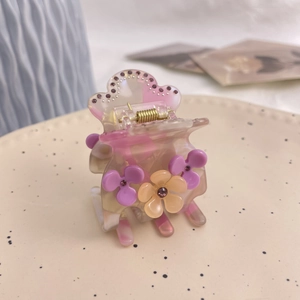 Pince à cheveux élégante en acétate violet avec fleurs, strass et texture marbrée chic