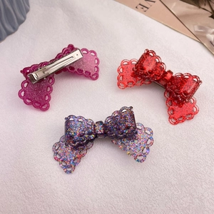 Set of three glittery lace bow hair clips in purple and red for festive holiday styling