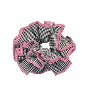 Plaid checkered scrunchie with pink ruffle edges for a sweet and fresh hairstyle