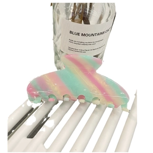 Large acetate hair claw clip with pink and green marble stripes for thick hair styling