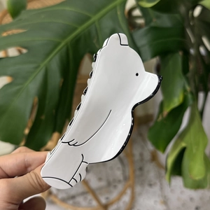 Pince à cheveux minimaliste en acétate blanc en forme d'ours polaire avec contours noirs