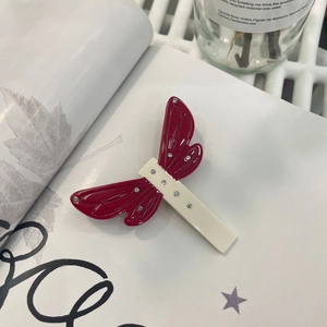 Minimalist dragonfly acetate hair clip with red and white wings and rhinestone accents