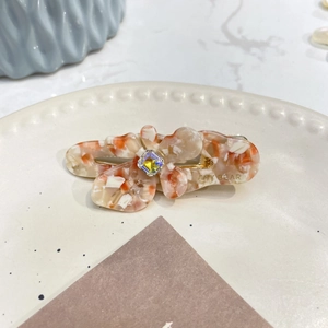 Fermaglio per capelli floreale in acetato ambrato marmorizzato con cristallo centrale
