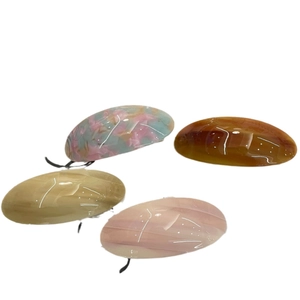 Minimalist acetate hair clips in oval shape featuring amber and marble textures