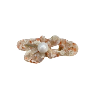 Elegant butterfly acetate hair clip with marble texture and pearl detail on white background