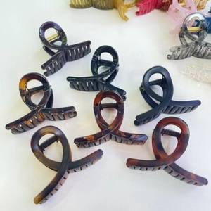 Detail view of colorful monster acetate hair claws in various finishes and colors