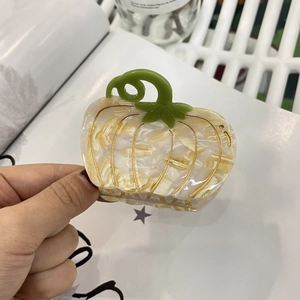 Creative pumpkin acetate hair claw clip with golden veins and green leaf detail
