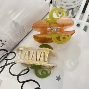 Creative pumpkin acetate hair claw clips in orange and cream marble for stylish hair styling