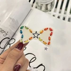 Cute white star hair clip with rainbow crochet ribbon trim and bow design for women