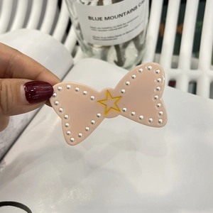 Pink bow hair clip with yellow star and faux pearl trim for Y2K girls aesthetic