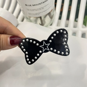 Y2K style black bow hair clip with pearl edges and star pattern for women