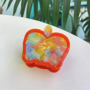 Cute apple-shaped colorful acetate hair claw clip with vibrant orange marbling for women