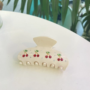 Creamy acetate hair claw clip with sparkling red rhinestone cherry and green leaf patterns