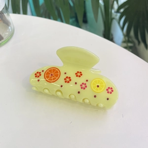 Acetate hair claw clip with lemon slices and small red rhinestones for hair styling