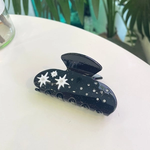 Black acetate hair claw clip with sparkling rhinestones and silver star patterns