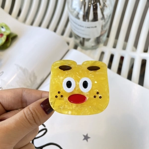 Pince à cheveux Y2K en acétate jaune à texture marbrée avec visage de monstre mignon