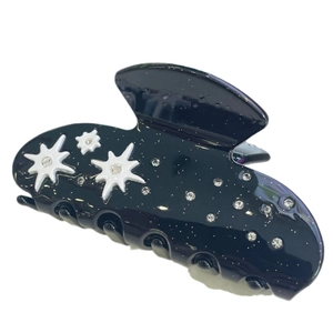 Black acetate hair claw clip with silver glitter and white star pattern decoration